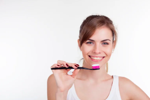 a girl holding a toothbrush