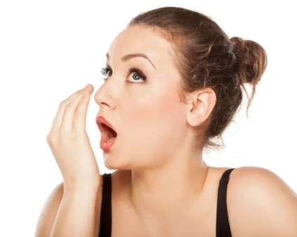 a girl smelling her mouth